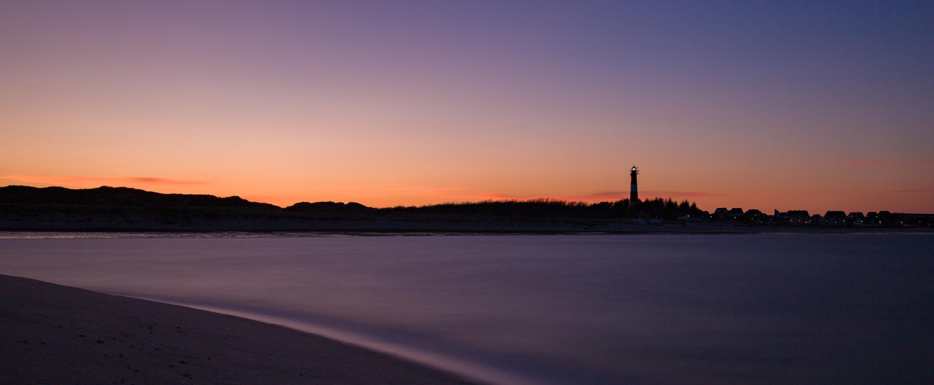 The Hörnum lighthouse at sunset with purple and orange colors